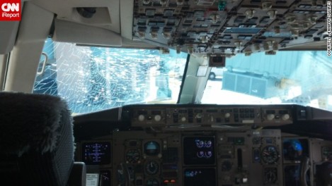 a cockpit of an airplane with a broken window