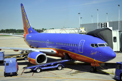 a blue and orange airplane with a trailer