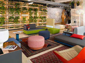 a room with colorful furniture and a wood wall