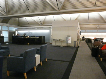a lounge area with chairs and a reception desk