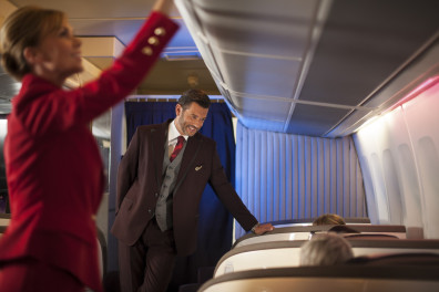 a man in a suit standing on an airplane