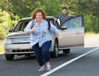 a woman running away from a car