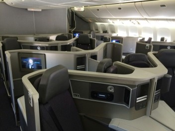 a room with rows of seats and screens