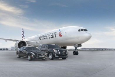 a jet airplane and cars parked on a runway